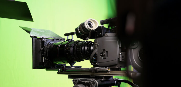 Behind the scenes. BTS of TV commercial movie film or video shooting production which pro camera crew setting up on green screen for chroma key technique in studio. Greenscreen background shooting set