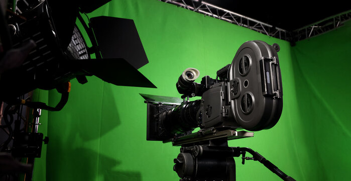 Behind the scenes. BTS of TV commercial movie film or video shooting production which pro camera crew setting up on green screen for chroma key technique in studio. Greenscreen background shooting set