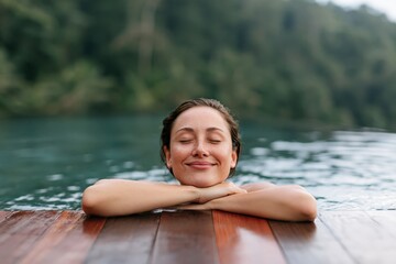 Fototapeta premium Closeup smiling woman resting at wooden pool edge by a lake for relaxing wellness background and summer banner