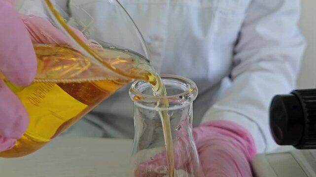Mixing liquids in a laboratory setting at a science school during a chemistry class