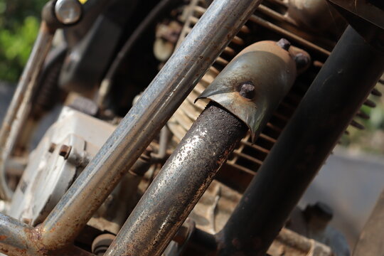 Exhaust pipe from engine block close up view. Parts of an internal combustion engine from an old motorcycle
