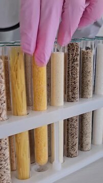 Different types of grains and pasta displayed in clear tubes for easy viewing and comparison