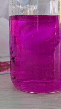 Mixing colors in clear jars to create vibrant shades during a science experiment