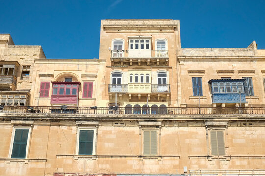 Traditional Maltese building facade with colored balconies