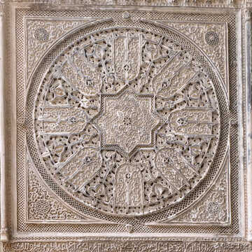 Ornate carved stone medallion with geometric star pattern