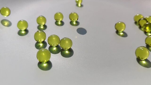 Fish oil capsules scattered on a white surface. Omega three supplement, nutrition, health, dietary supplement.