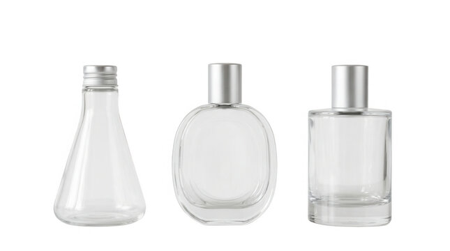 Elegant collection of clear glass bottles for perfume and cosmetic products displayed on white surface