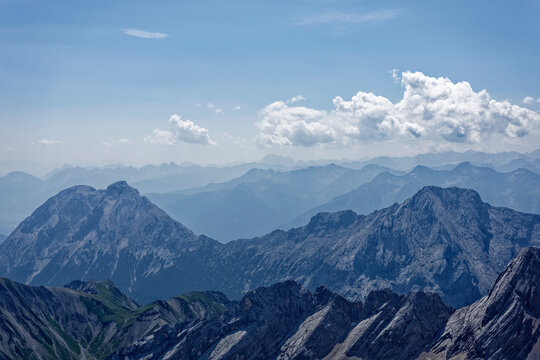 Layered Alpine Mountain Ranges and Paraglider Viewed from Zugspitze Summit