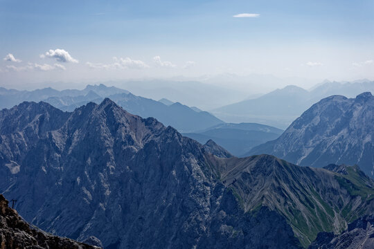 Layered Alpine Mountain Ranges and Paraglider Viewed from Zugspitze Summit