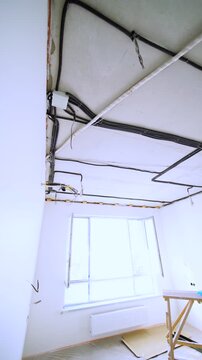 Exposed electrical wiring in bright room under renovation