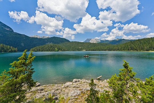 Black Lake in Durmitor National Park with scenic mountain landscape and forest.