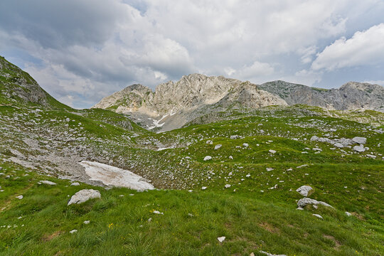 Durmitor National Park mountain landscape with rocky green hills and clouds
