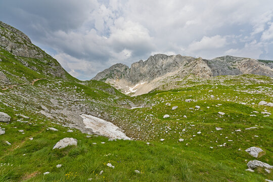Durmitor National Park mountain landscape with rocky green hills and clouds