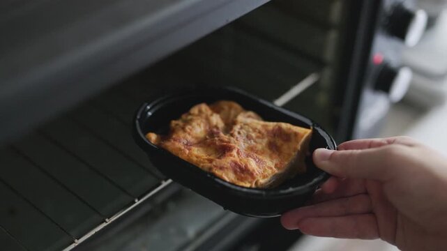 packaged frozen lasagna in a clear plastic container with frost details