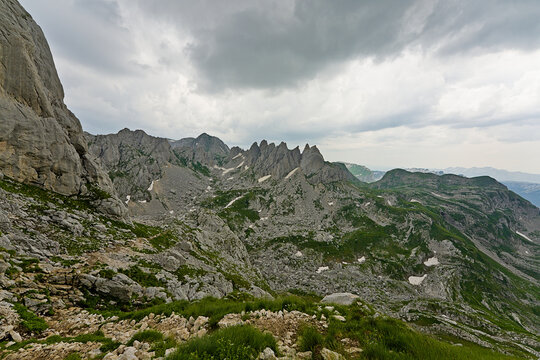 Durmitor National Park mountain landscape with rocky green hills and clouds