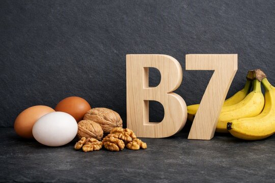 Biotin b7 food sources display with eggs walnuts and bananas arranged for nutritional poster and health background about vitamin benefits