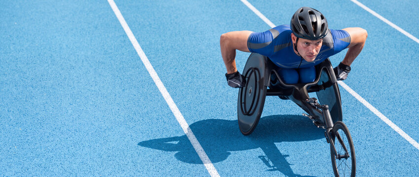 Wheelchair racer speeding on a running track during an intensive para-athletics competition under bright sunlight, capturing determination and adaptive sports performance in high angle view