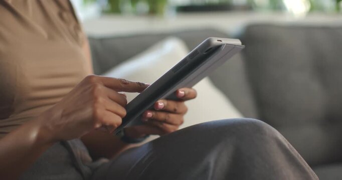 Starting with tablet on lap, right index finger is tapping and swiping to browse app