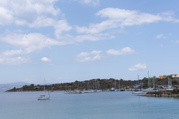 Obraz premium Mediterranean coastal harbor with sailboats and white buildings
