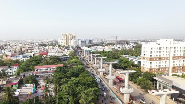 Elevated metro rail piers under construction beside a city road - August, 2026, Chennai, India