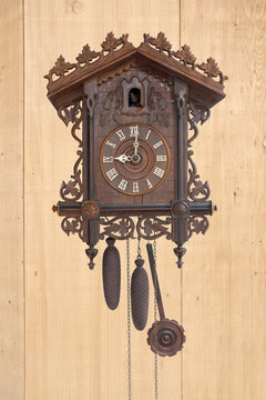 Antique cuckoo clock on the wooden board