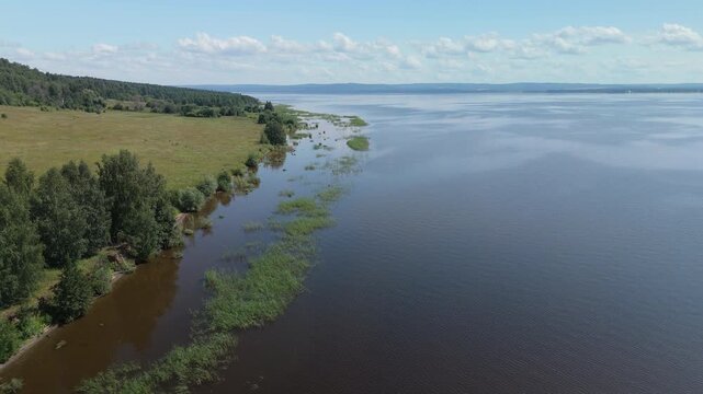 Aerial view of the coast of the Kama river covered with trees