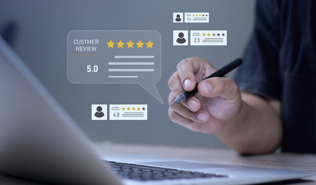 Customer review rating, user feedback assessment, and testimonial evaluation concept with hand holding stylus pen pointing at glowing 5-star customer review HUD on laptop screen.