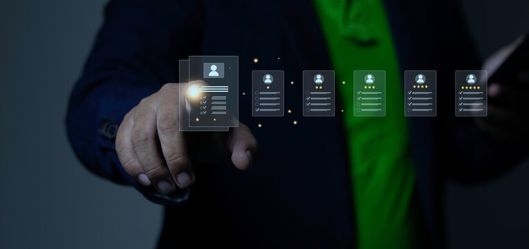 Human resources recruitment, candidate qualification screening, and performance evaluation concept with businessman pointing finger at glowing profile document icons with star ratings.