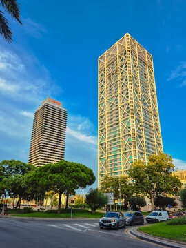 Barcelona Spain August 16 2026 Hotel Arts Barcelona and Torre MAPFRE skyscrapers with traffic and city streets in the evening.