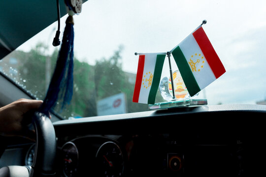 Tiny flags wave atop a car dashboard