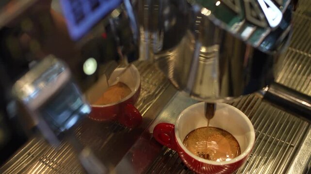 Espresso brewing into cup from coffee machine
