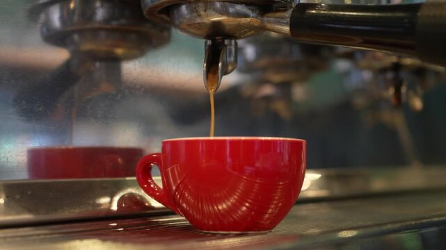 Fresh espresso pouring into coffee cup
