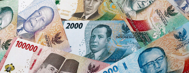 Indonesian rupiah money banknotes pile on table. Indonesia bills of IDR currency close up © Larysa