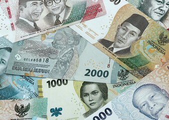 Indonesian rupiah money banknotes pile on table. Indonesia bills of IDR currency close up © Larysa