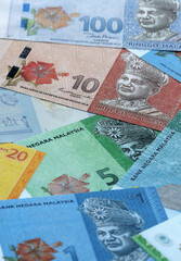 Malaysian ringgit money banknotes pile on table. Malaysia bills of MYR currency close up © Larysa