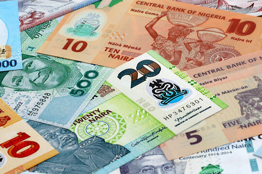 Nigerian naira money banknotes pile on table. Nigeria bills of NGN currency close up