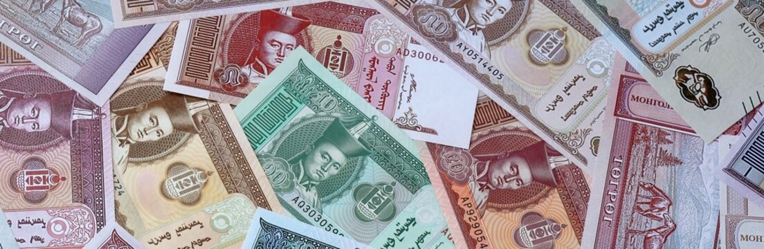 Mongolian tugrik money bills in pile. Big amount of Mongolia MNT currency cash close up