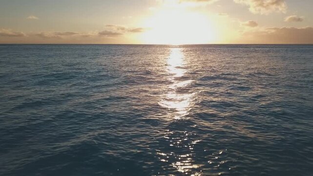 Flight over the sea surface during sunset