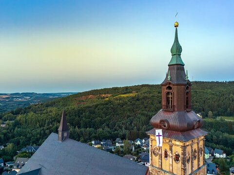 Aerial view of St. Wolfgang's Church tower in the mining town Schneeberg, Ore Mountains with panoramic view of Erzgebirge, Germany