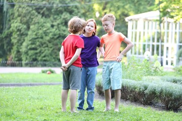 Fototapeta premium Little friends spending time together on green grass outdoors