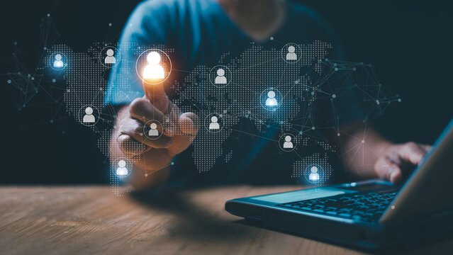 Global networking and workforce connection concept. Businessman selecting user icon on world map. Representing international business, communication, collaboration and professional community.