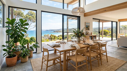 Fototapeta premium Modern coastal dining room interior with wooden dining table and large panoramic windows overlooking the ocean and beach