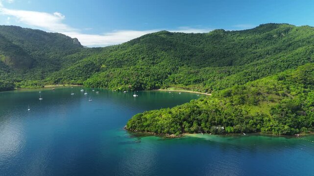 Aerial view of the calm and green lagoon with sailing boats on the island of Ilha Grande, Brazil
