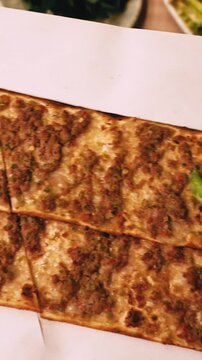 Traditional Konya Etli Ekmek Served with Lemon and Peppers