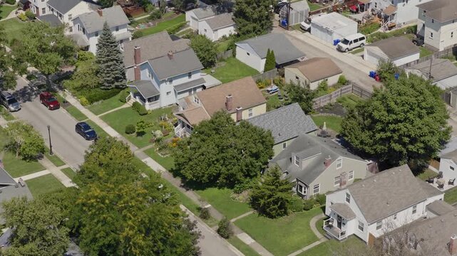 Medium income and middle class Midwestern American homes, houses, rental property residences, and townhouse duplexes in average older neighborhood outside Columbus, OH in Ohio suburb from drone aerial