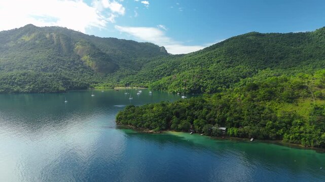 Aerial view of the calm and green lagoon with sailing boats on the island of Ilha Grande, Brazil