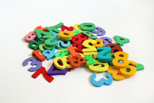 Colorful Foam Numbers Scattered on White Background, Early Math Education and Counting Concept