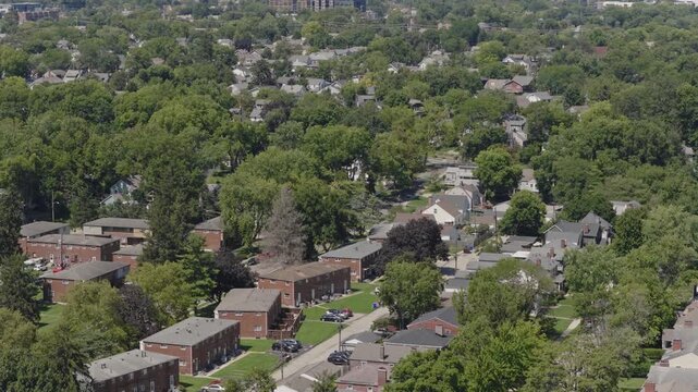 Medium income and middle class Midwestern American homes, houses, rental property residences, and townhouse duplexes in average older neighborhood outside Columbus, OH in Ohio suburb from drone aerial