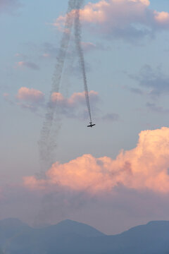 Single Aerobatic Plane Trailing Smoke Over Pink Clouds At Sunset &mdash; Aerobatic Air Show In Chilliwack, BC Canada