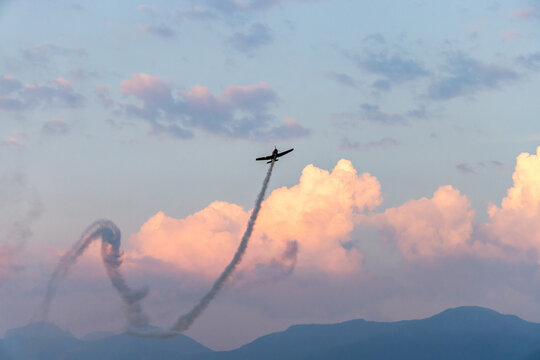 Aerobatic Air Show Plane Over Chilliwack BC Canada Climbing Through Pink Clouds With Smoke Trail